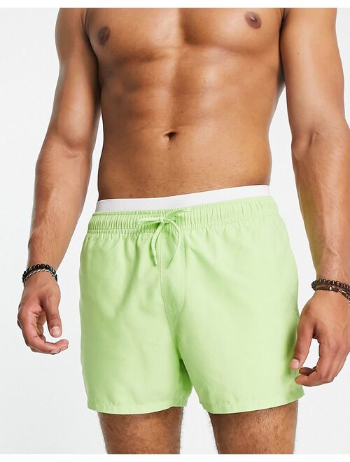 ASOS DESIGN swim shorts in short length with double waistband in lime green