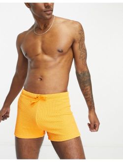 textured swim trunks in orange