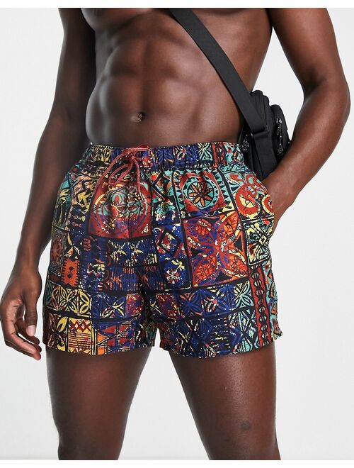 ASOS DESIGN swim shorts in short length with retro tapestry print in orange