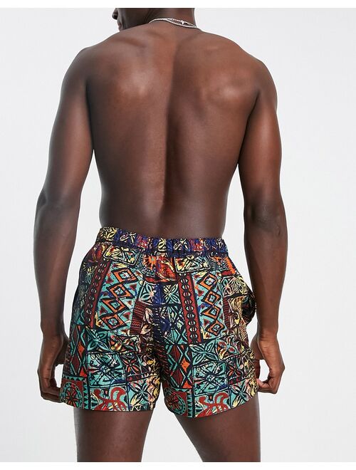 ASOS DESIGN swim shorts in short length with retro tapestry print in orange