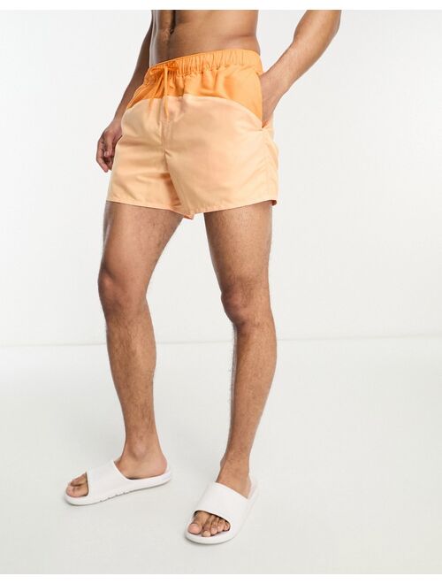 ASOS DESIGN swim shorts in short length with cut-and-sew in orange