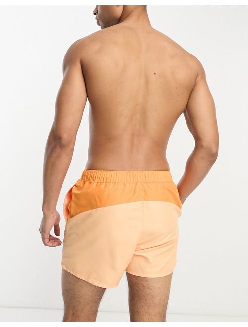 ASOS DESIGN swim shorts in short length with cut-and-sew in orange