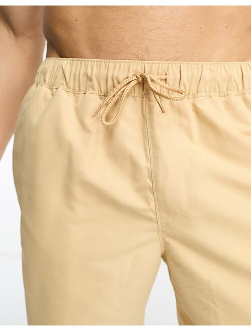 ASOS DESIGN swim shorts in mid length in beige