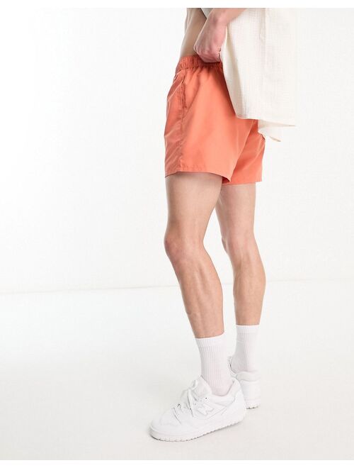 ASOS DESIGN swim shorts in short length in orange