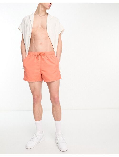 ASOS DESIGN swim shorts in short length in orange