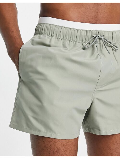 ASOS DESIGN swim shorts in short length with double waistband in light green