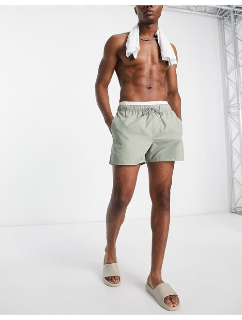 ASOS DESIGN swim shorts in short length with double waistband in light green