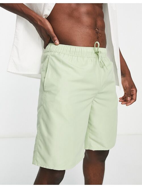 ASOS DESIGN swim shorts in long length in light green