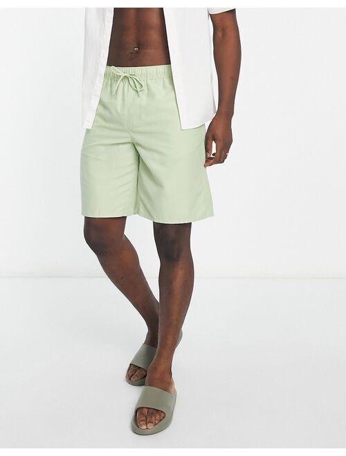 ASOS DESIGN swim shorts in long length in light green