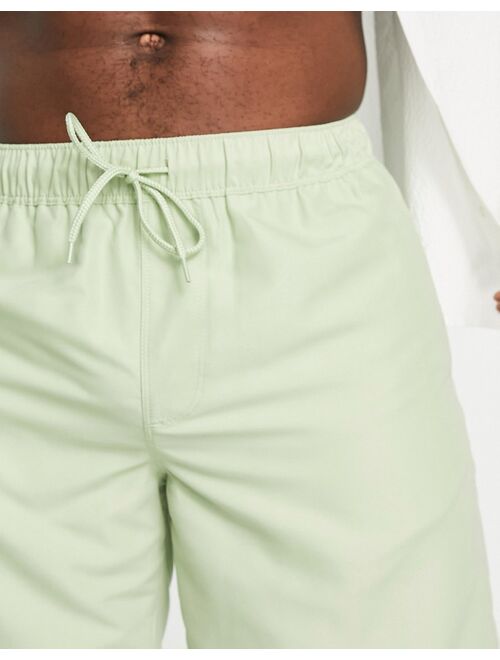 ASOS DESIGN swim shorts in long length in light green