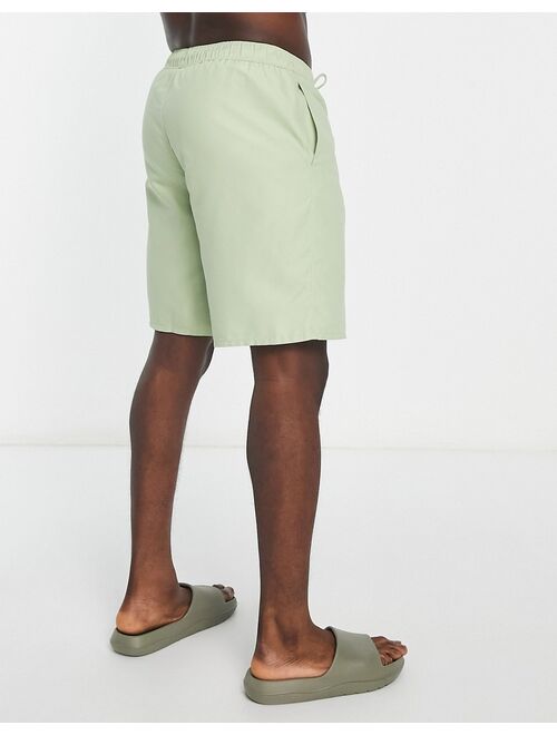 ASOS DESIGN swim shorts in long length in light green