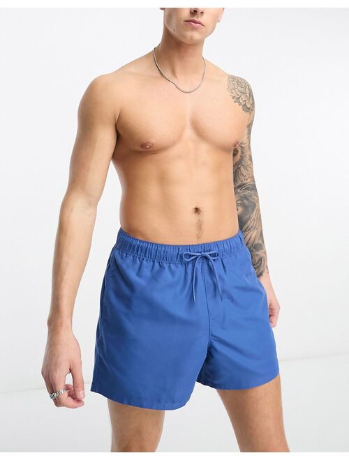 ASOS DESIGN swim shorts in short length in blue