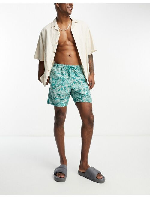 ASOS DESIGN swim shorts in short length in floral print in green