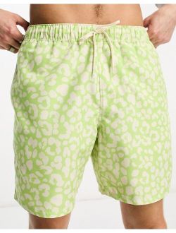 swim shorts in short length in leopard print in green