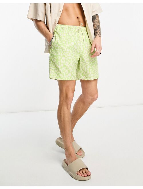 ASOS DESIGN swim shorts in short length in leopard print in green