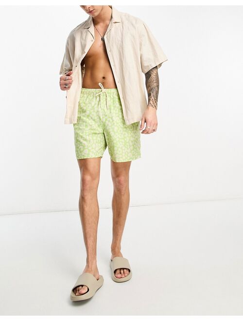 ASOS DESIGN swim shorts in short length in leopard print in green