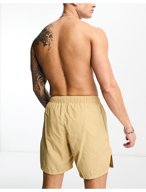 ASOS DESIGN swim shorts in short length in beige