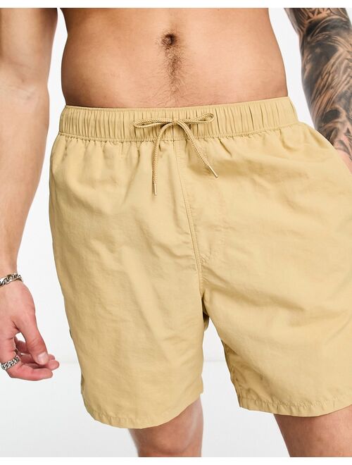 ASOS DESIGN swim shorts in short length in beige