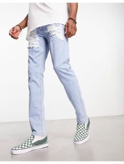 skinny jeans with heavy rips in light wash blue