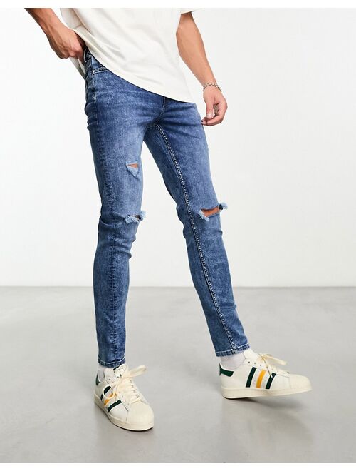 ASOS DESIGN skinny jeans with knee rips in mid wash blue