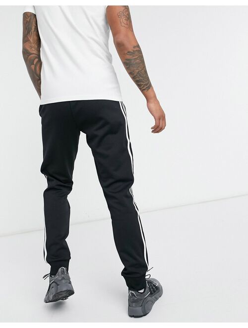 adidas Originals adicolor three stripe skinny sweatpants in black