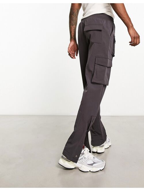 The Couture Club cargo pants in charcoal with snap hem