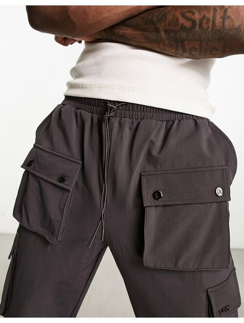 The Couture Club cargo pants in charcoal with snap hem