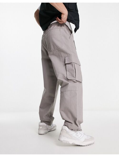 ASOS DESIGN oversized tapered cargo pants in beige with belt