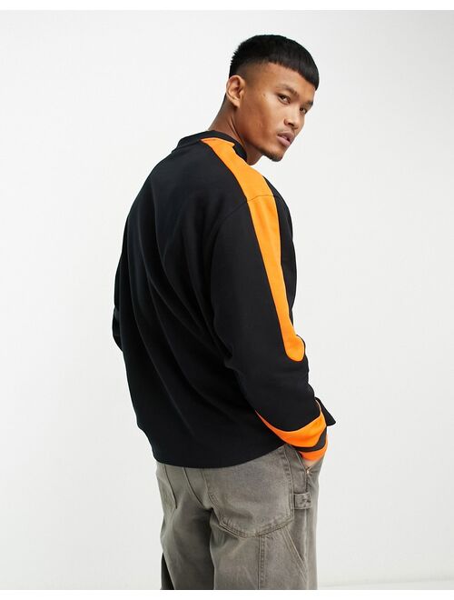 ASOS DESIGN oversized hockey jersey with city print in black and orange