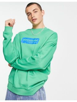 ASOS Daysocial oversized sweatshirt with blue badge logo print in green