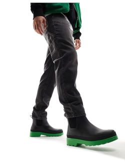 chelsea wellington boots in black with green contrast sole