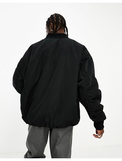 COLLUSION Unisex reversible ultimate oversized bomber jacket in black & gray tonic