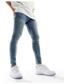 spray on jeans with power stretch in tinted mid wash blue
